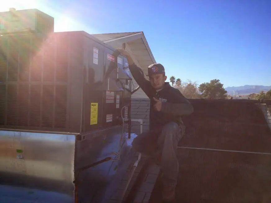 HVAC technician performing HVAC Inspection on a rooftop unit in Hope Mills
